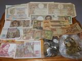 a tray full of money and coins sitting on a table