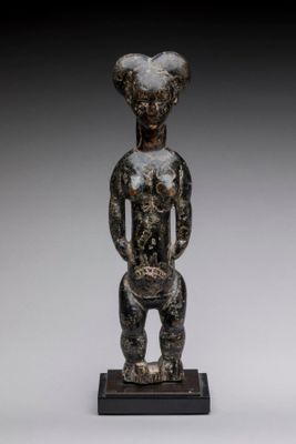 une statue en bronze représentant un homme coiffé d'une tête de chèvre