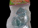 a bag of blue plastic rocks on a black background