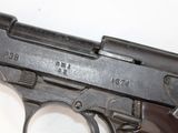 a close up of a gun on a white surface