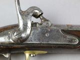 a close up of a gun on a white surface