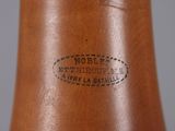 a close up of a brown vase with a label on it