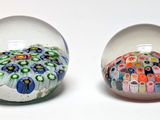 two glass balls that have different designs inside of them