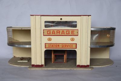 a small toy garage with shelves and shelves on the side