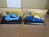 two model cars that are on display on a table