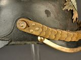 a close up of a helmet with a gold decoration on it