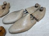 three wooden shoes that are sitting on a table