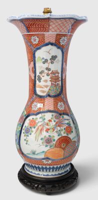 a vase that is sitting on a stand on a white surface