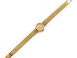 a gold wrist watch with a mesh band