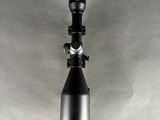 a black and white photo of a telescope mounted on a wall