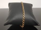 a close up of a black pillow with a gold chain on it
