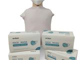 trois boîtes de masques faciaux et une tête de mannequin sur fond blanc