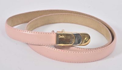 pink leather belt with gold buckle on a white background
