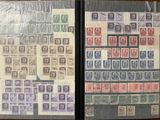 two books with stamps on them sitting on top of a wooden table