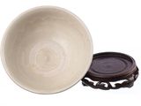 a white bowl with a brown lid sitting on a table