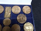 a lot of coins in a blue box on the table