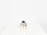 silver plated coffee pot with a black lid on a white table