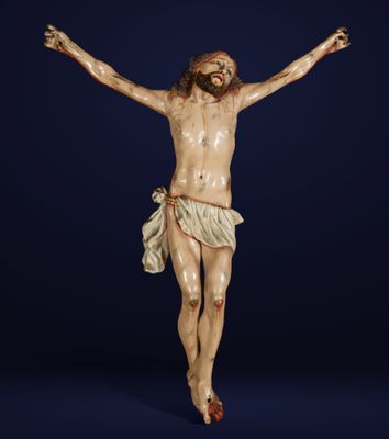 a statue of jesus on the cross on a blue background