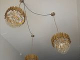 three chandeliers hanging from the ceiling in a room