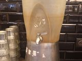 a blender sitting next to a stack of cups on a counter