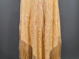 a yellow shawl with fringes on a mannequin mannequin mannequin mannequin mannequin mannequin mannequin manne
