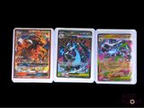 three different pokemon cards sitting on top of each other on a table