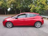 a picture of a red car parked on the side of the road