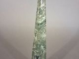 an image of a green stone obelisk on a white background