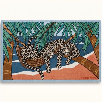two leopards sleeping in a hammock under palm trees on the beach