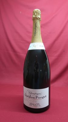 a close up of a bottle of champagne on a red background