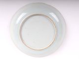 an image of a blue plate with a gold rim on a white surface