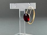 clear acrylic jewelry display stand with a pair of earrings on it