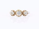 a three stone diamond ring set in 18k yellow gold