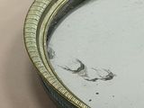 a mirror with a bird on it on a table