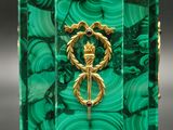 an image of a green marble clock with a gold emblem on it