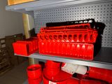 many red plastic containers on a shelf in a store