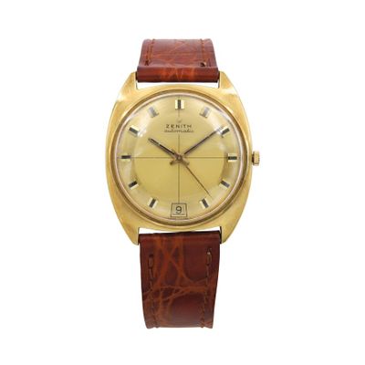 a gold plated wrist watch with brown leather strap