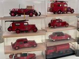 a lot of toy cars that are in a display case