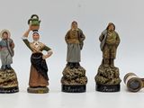 several figurines of people are shown on a white surface