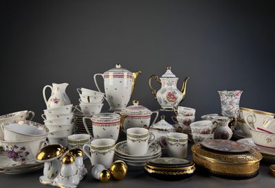 many different types of tea cups and saucers on the table