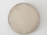 a close up of a silver coin on a white surface