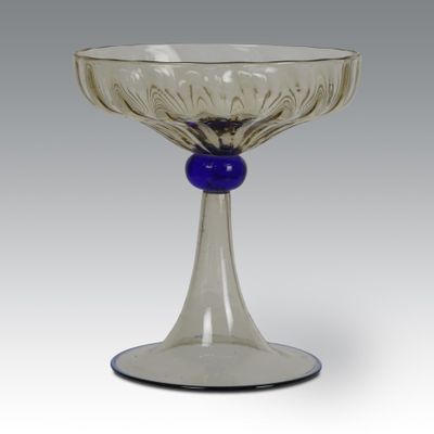 an image of a glass bowl with a blue bead on the rim