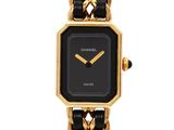 an image of a black and gold watch with a chain link bracelet