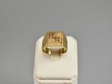 a close up of a gold ring on a white display stand