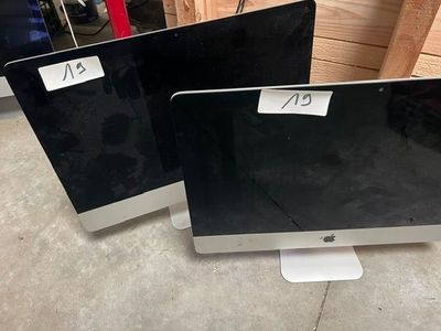 two computer monitors sitting on top of each other in a room