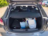 the back of a car with a trunk full of items in it