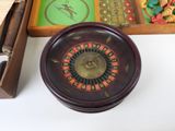 a wooden box with a roule wheel and a wooden box with dice pieces