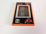 an orange and black gameboy sitting on top of a white table