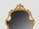 a mirror that is sitting on a table in front of a white wall