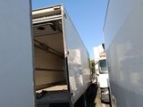 two white trucks that are parked next to each other